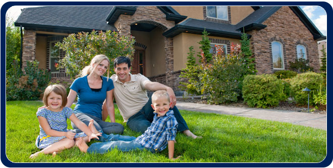 Homeowners in front of house with a sign indicating it has been treated and is bug free. They look happy